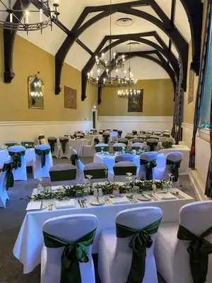 a banquet hall with white tables and green bows at Stirling Highland Hotel- Part of the Cairn Collection in Stirling