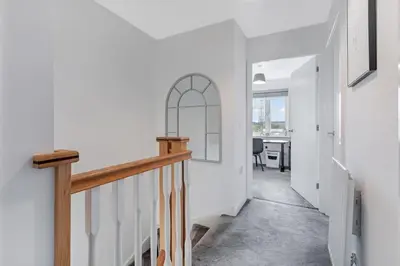 a hallway of a home with a staircase and a table at Scenic getaway, open plan home! 2bed park for free in Eaglesham