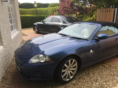 a blue car parked in front of a house at Cottage in Ayr