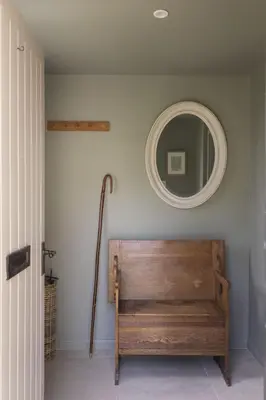 a mirror and a wooden bench in a room at Shepherds Cottage, Pentland Hills in Nine Mile Burn