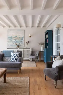 a living room with two couches and a table at The Coach House, Pentland Hills in Nine Mile Burn