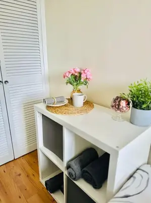 a white table with flowers on it in a room at Dumbarton cosy home, Loch Lomond in Dumbarton