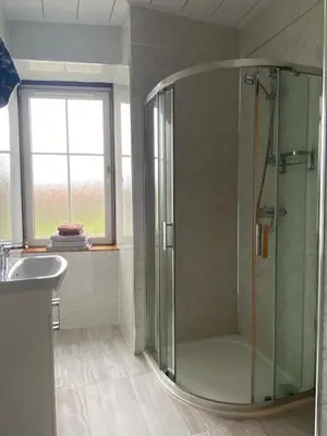 a bathroom with a shower and a sink at Kingarth Hotel in Kilchattan