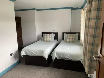 two beds sitting next to each other in a room at Kingarth Hotel in Kilchattan