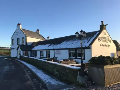 a inn with a street light in front of it at Kingarth Hotel in Kilchattan