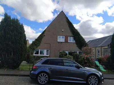 a car parked in front of a house at Double Ensuite room, 1-minute walk to bus stop in Edinburgh