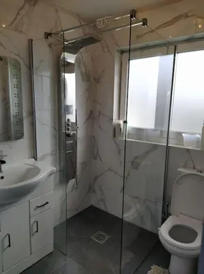 a bathroom with a shower and a toilet and a sink at Double Ensuite room, 1-minute walk to bus stop in Edinburgh