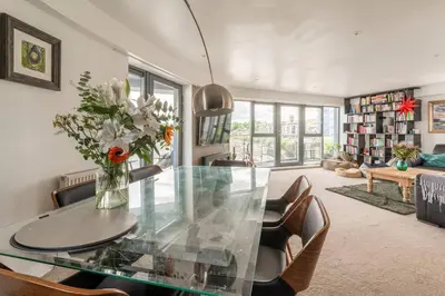 a dining room with a glass table and chairs at Calming Sea View City Apartment in Edinburgh