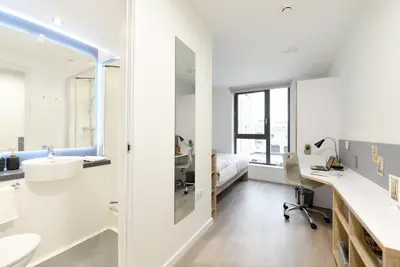a white bathroom with a sink and a desk at For Students Only St Mungo's in Glasgow in Glasgow