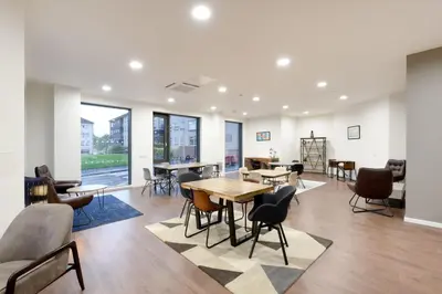 a room with tables and chairs in a building at For Students Only St Mungo's in Glasgow in Glasgow