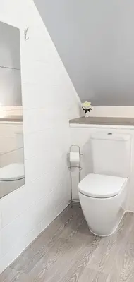 a white bathroom with a toilet and a sink at Erradale in Campbeltown