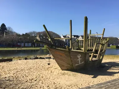 a wooden boat sitting on top of a sandy beach at Lakeview Guest House in Stranraer