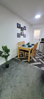 a dining room with a table and chairs at Stylish home in Linlithgow Near Edinburgh Airport Free parking Free WiFi in Linlithgow