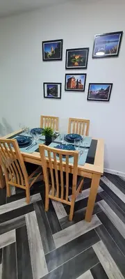 a dining room table with four chairs and a table and chairsktop at Stylish home in Linlithgow Near Edinburgh Airport Free parking Free WiFi in Linlithgow
