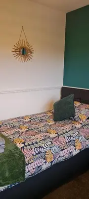 a bed with two pillows on it in a room at Stylish home in Linlithgow Near Edinburgh Airport Free parking Free WiFi in Linlithgow
