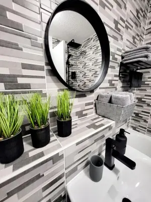 a bathroom with potted plants and a mirror at Stylish home in Linlithgow Near Edinburgh Airport Free parking Free WiFi in Linlithgow