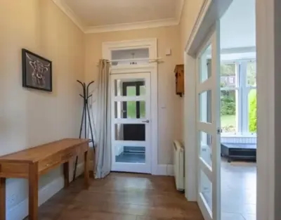 a room with a wooden bench and a door at Room 1, Loch Etive House, Connel near Oban in Connel