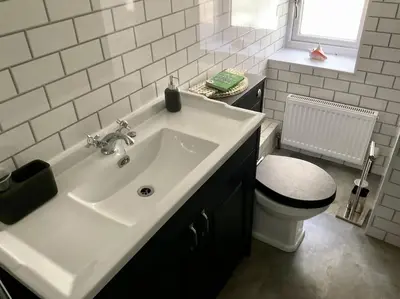 a bathroom with a sink and a toilet at Pirnmill Home with a view in Pirnmill
