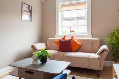 a living room with a couch and a table at Airth House in Airth