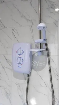 a white blow dryer in a bathroom at Castlemilk Apartment in Glasgow