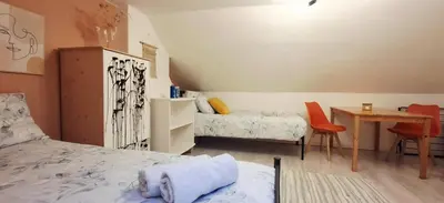 a bedroom with a bed and a desk and a table at Mini hotel with home facilities in Hamilton West in High Blantyre