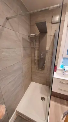 a shower with a glass door in a bathroom at Mini hotel with home facilities in Hamilton West in High Blantyre