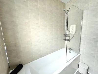a bathroom with a shower and a bath tub at Charming 3-Bed Oasis-free parking in Glasgow