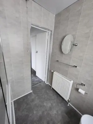 a bathroom with a toilet and a mirror and a door at Charming 3-Bed Oasis-free parking in Glasgow