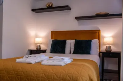a bedroom with a bed with towels on it at Ardbeg Apartment in Oban
