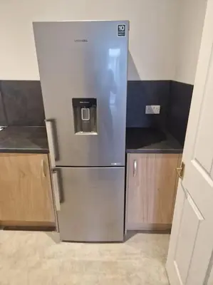 a stainless steel refrigerator in a small kitchen at M Rooms 97a at the Brandy Bar in Kirk of Shotts