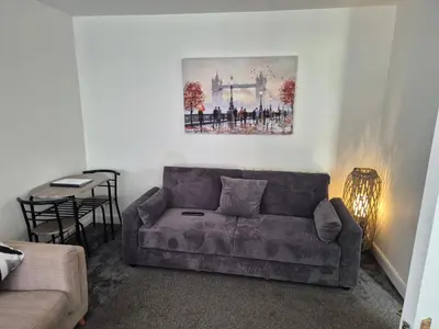 a living room with a couch and a table at M Rooms 97a at the Brandy Bar in Kirk of Shotts