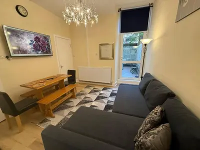 a living room with a couch and a table at One Bedroom Flat in Central Edinburgh Old Town , Heart of Edinburgh Flat Sleeps 4 in Edinburgh