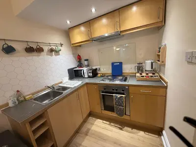 a small kitchen with a sink and a stove at One Bedroom Flat in Central Edinburgh Old Town , Heart of Edinburgh Flat Sleeps 4 in Edinburgh