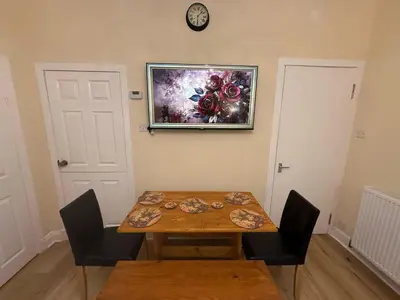 a dining room with a table and a picture on the wall at One Bedroom Flat in Central Edinburgh Old Town , Heart of Edinburgh Flat Sleeps 4 in Edinburgh
