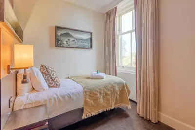 a bedroom with a bed and a window at Apex Dunblane Hydro in Dunblane