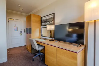 an office with a desk and a large screen television at Apex Dunblane Hydro in Dunblane