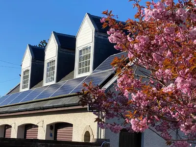 a church with solar panels on its roof at WHITEHILL STABLES in Kirknewton