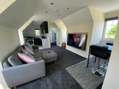 a living room with a couch and a table at WHITEHILL STABLES in Kirknewton