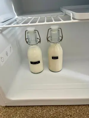 two bottles of milk sitting in an open refrigerator at Acorn House Callander in Callander
