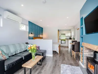 a living room with a couch and a table and a living room at Laigh Letterpin Lodge in Girvan