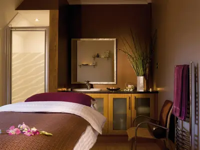 a bedroom with a bed with a mirror and a sink at Macdonald Houstoun House in Livingston