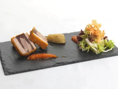 a black plate of food with a salad and carrots at Macdonald Houstoun House in Livingston