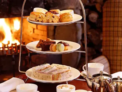 a three tiered tray with different types of cakes and pastries at Macdonald Houstoun House in Livingston