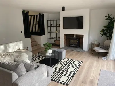 a living room with a couch and a fireplace at Sleeps7-Parking-Garden-Patio in Johnstone