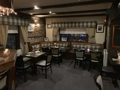 a dining room with tables and chairs in a restaurant at Lion and Unicorn Hotel in Thornhill