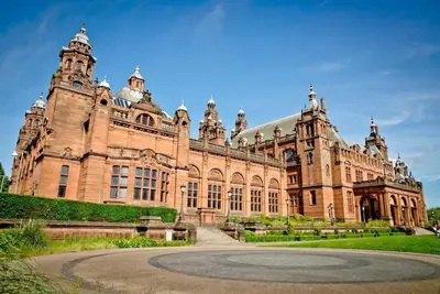 a large brick building with a courtyard in front of it at Rustic Top Floor West End Pad With Balcony, Parking next to Byers Road, Aston Lane, Glasgow Uni in Glasgow