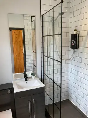 a bathroom with a sink and a glass shower at Rustic Top Floor West End Pad With Balcony, Parking next to Byers Road, Aston Lane, Glasgow Uni in Glasgow