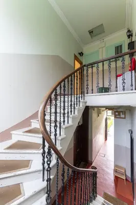 a spiral staircase in a home with white walls at Ochil View in Stirling