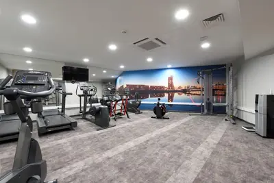 a gym with tread machines and a wall mural at Student Only Ensuite Room in Central Glasgow in Glasgow