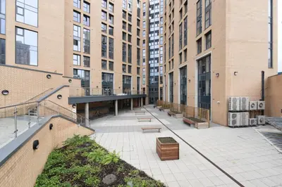 an empty courtyard with benches and tall buildings at Student Only Ensuite Room in Central Glasgow in Glasgow